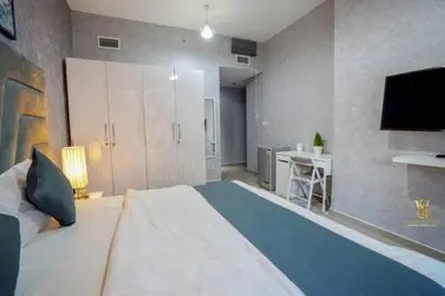 a large bedroom with a large bed and a television at Luxury apartment in Dubai marina 5 min walk to JBR Beach-3BHK Apartment in Dubai