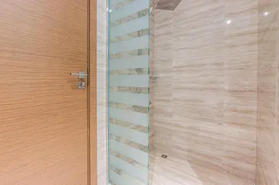 a staircase leading up to a wooden door at 1BR Apt Residence Along Business Bay Canal in Dubai