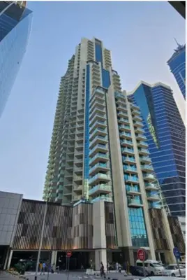 a large tall building in a city at 1BR Apt Residence Along Business Bay Canal in Dubai