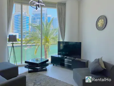 a living room with a tv and a large window at Unforgettable View & Experience Over Dubai Canal in Dubai