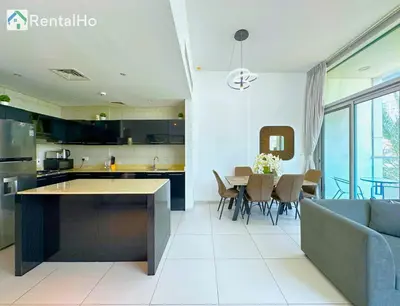 a kitchen and living room with a couch and a table at Unforgettable View & Experience Over Dubai Canal in Dubai