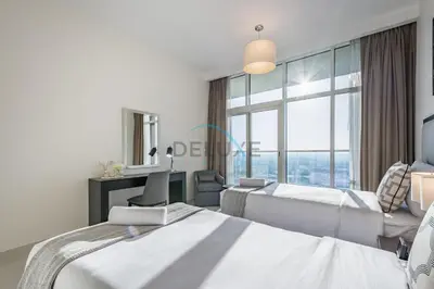 a hotel room with two beds and a window at Elegant 2BR in Tower 108 Jumeirah Village Circle by Deluxe Holiday Homes in Dubai