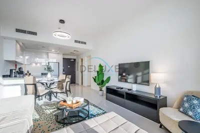 a living room with a couch and a table at Elegant 2BR in Tower 108 Jumeirah Village Circle by Deluxe Holiday Homes in Dubai