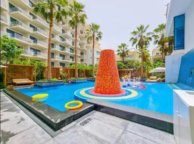 a pool at a resort with a large building at FIVE Palm Residence - Elegant Home in Dubai
