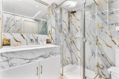 a bathroom with a shower and a sink at Gorgeous 2BR APT in Dubai Marina with Canal View in Dubai