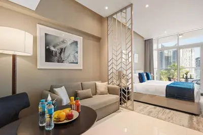 a living room with a couch and a bed at Luxury Smart Studio with Canal View Business Bay - Damac Maison Prive in Dubai