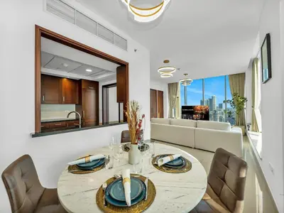 a dining room with a table and chairs at New Downtown Setup - Penthouse with Panoramaic Views in Dubai