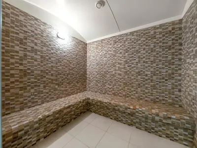 a bathroom with brown brick walls and a ceiling at New Downtown Setup - Penthouse with Panoramaic Views in Dubai