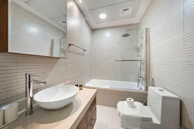a white bathroom with a sink and a tub at Silkhaus New and Stylish 2BR in Dubai Marina in Dubai