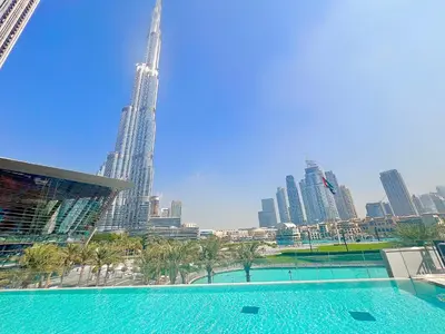 a view of the burj khalifa from a swimming pool in the city at Luxury 1BR 5min to Dubai Mall Burj Khalifa View from pool in Dubai