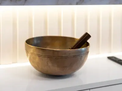 a metal bowl with two chopsticks in it on a counter at Luxury 1BR 5min to Dubai Mall Burj Khalifa View from pool in Dubai