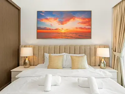 a bedroom with a large bed with two lamps at Luxury 1BR 5min to Dubai Mall Burj Khalifa View from pool in Dubai
