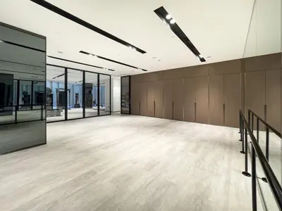 a large empty room with wood floors and glass walls at Luxury 1BR 5min to Dubai Mall Burj Khalifa View from pool in Dubai