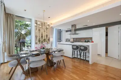 a dining room and kitchen with a table and chairs at Livbnb - Luxury 3B with Maid's Room, Partial Sea View in Dubai