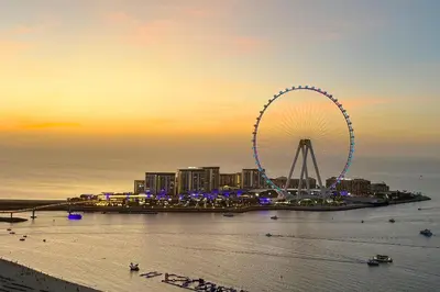 a large ferris wheel in front of a city at Livbnb - Luxury 3B with Maid's Room, Partial Sea View in Dubai