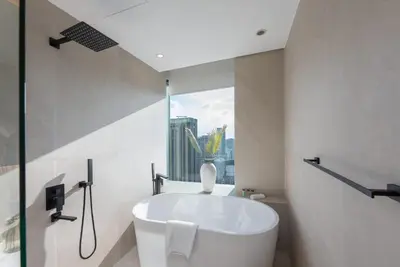 a bathroom with a bath tub and a window at StayShort - Grand Stay in this 1 Bedroom Flat that Sleeps 4 in Dubai