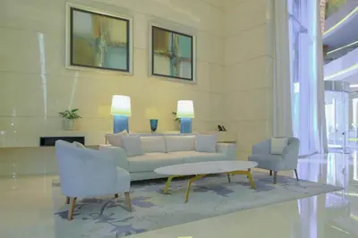 a living room with a couch and two chairs at StayShort - Grand Stay in this 1 Bedroom Flat that Sleeps 4 in Dubai