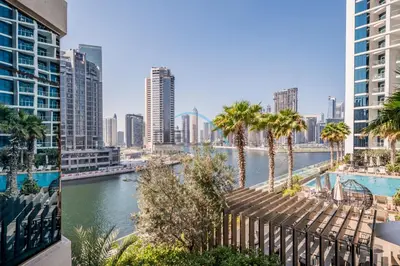 a view of a river with palm trees and buildings at Luxury Studio Apartment in Prive By Damac B, Business Bay by Deluxe Holiday Homes in Dubai