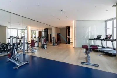 a gym with treadmills and cardio equipment in a room at Luxury Studio Apartment in Prive By Damac B, Business Bay by Deluxe Holiday Homes in Dubai