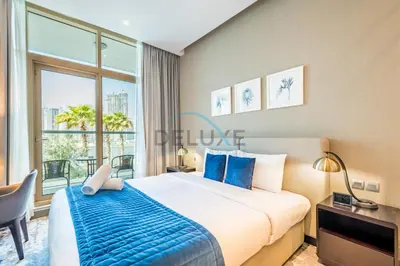 a bedroom with a bed and a large window at Luxury Studio Apartment in Prive By Damac B, Business Bay by Deluxe Holiday Homes in Dubai