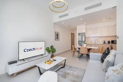 a living room with a couch and a tv at Stylish Urban Living - 1-bedroom in Burj Royale in Dubai