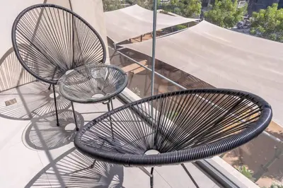 a pair of metal chairs sitting on a balcony at Stylish Urban Living - 1-bedroom in Burj Royale in Dubai