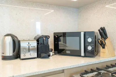 a kitchen counter with a microwave and a toaster oven at Stylish Urban Living - 1-bedroom in Burj Royale in Dubai