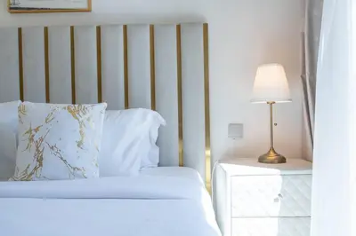 a bedroom with a bed and a table with a lamp at Stylish Urban Living - 1-bedroom in Burj Royale in Dubai