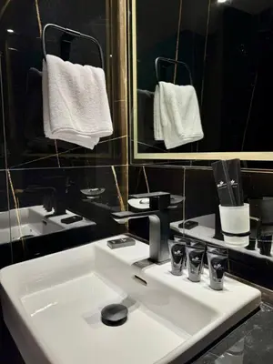 a bathroom with a white sink and a mirror at Modern 1br In Jvc Pool, Balcony & Free Parking in Dubai