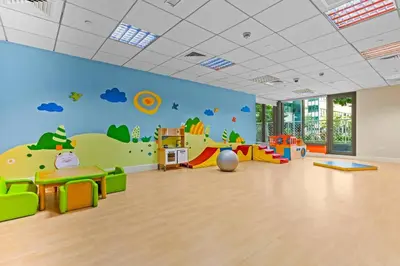 a childrens play room with a mural of a playground at Stylish 1BR with Iconic Burj and Fountain Views, Free Luxury Airport Pick Up Service in Dubai