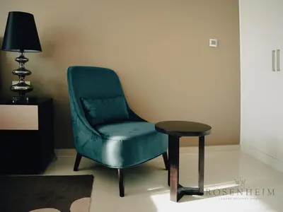 a blue chair and a table in a room at Modern Studio Escape - Pool, Gym & Relaxation in Dubai