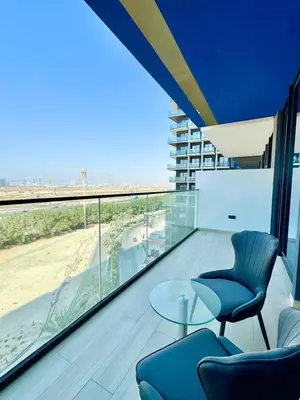 a room with two chairs and a table on a balcony at Cozy & Stylish 1br Apt Jvc Pool & Parking in Dubai