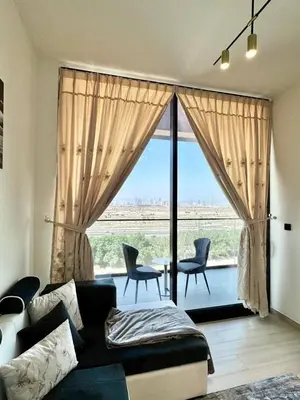 a living room with a couch and a large window at Cozy & Stylish 1br Apt Jvc Pool & Parking in Dubai