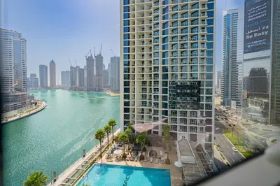an aerial view of a large building next to a river at Escape24 Cozy Studio with Pool & Canal View near Burj Khalifa in Dubai
