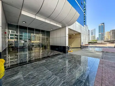 a large building with a pool in front of it at Urban Gem 2BR with Stunning Views in Dubai