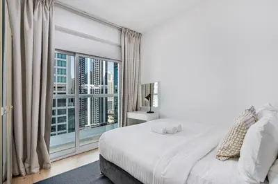a bedroom with a large bed and a large window at Urban Gem 2BR with Stunning Views in Dubai