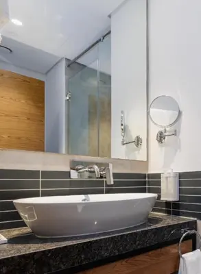 a bathroom with a large white sink and a mirror at Holiday Inn Dubai Jumeirah Village Circle by IHG in Dubai