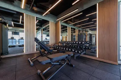 a gym with rows of exercise equipment in a building at Holiday Inn Dubai Jumeirah Village Circle by IHG in Dubai
