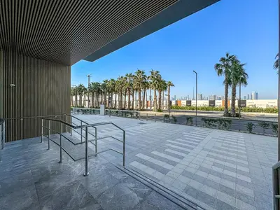 a view of a patio with palm trees at Lovely Studio in Mag 900, Meydan in Dubai
