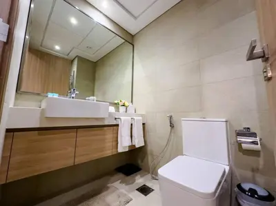 a bathroom with a sink and a toilet and a mirror at Naseem Elegant Studio Escape in Al Merkadh in Dubai