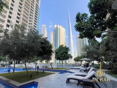 a park in the middle of a city with tall buildings at 29 Burj Boulevard - Premium 1BR - City Skyline view - Near Burj Khalifa - Downtown Dubai in Dubai