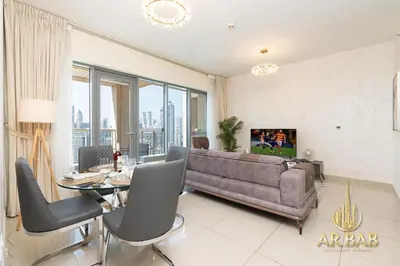 a living room with a couch and a table at 29 Burj Boulevard - Premium 1BR - City Skyline view - Near Burj Khalifa - Downtown Dubai in Dubai