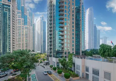 a view of a city with tall buildings at Luxurious Studio with Stunning Burj Khalifa, Pool & Lake Views Steps from Dubai Mall in Dubai