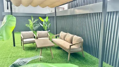 a living room with two chairs and a couch at 2BR with Extra-Large Balcony Canal & Burj Views by Vibel in Dubai