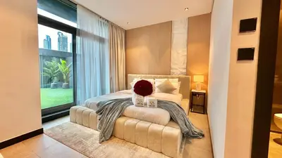 a bedroom with a bed and a large window at 2BR with Extra-Large Balcony Canal & Burj Views by Vibel in Dubai