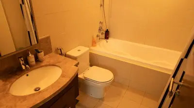a bathroom with a sink and a toilet and a tub at Boho Chic Haven Burj Khalifa view in Dubai