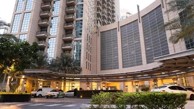 a large building with cars parked in front of it at Boho Chic Haven Burj Khalifa view in Dubai