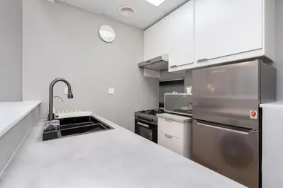 a kitchen with stainless steel appliances and a counter top at White Sage Stunning New Studio in Marina in Dubai