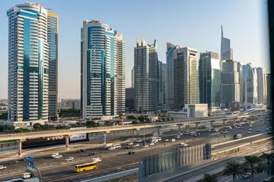 a city with a highway in front of tall buildings at White Sage Stunning New Studio in Marina in Dubai