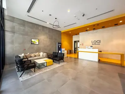 a lobby with a couch and chairs and a table at Stylish Studio APT with Pool and Gym in Dubai
